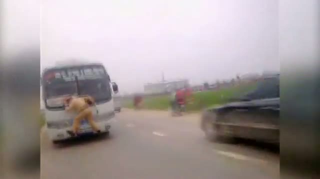 Vietnam - Cop Gets Wild Ride on Front of Bus video