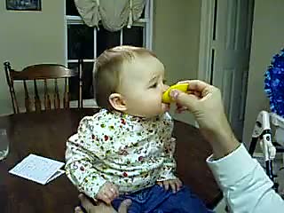 Funny Baby Eats a Sour Lemon
