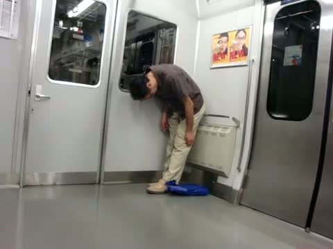 Guy falls asleep while standing on Tokyo train