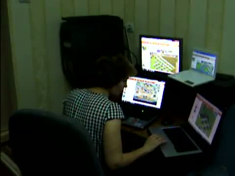 Mom playing Farmville on four computers