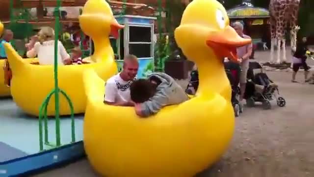 Two guys break children's duck ride
