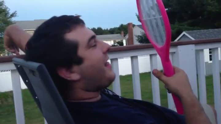 Guy Puts Tongue On Electric Fly Swatter