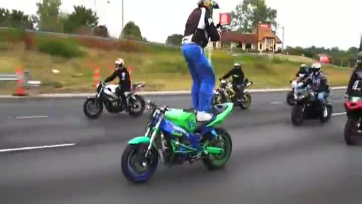 Guy Stands Backwards on Motorcycle on Freeway