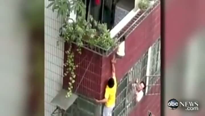 Chinese Kid Dangles From Balcony