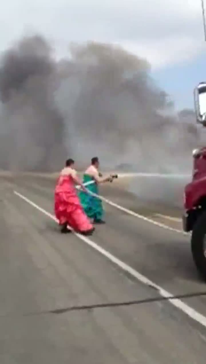 Firemen in Drag Put Out Truck Fire