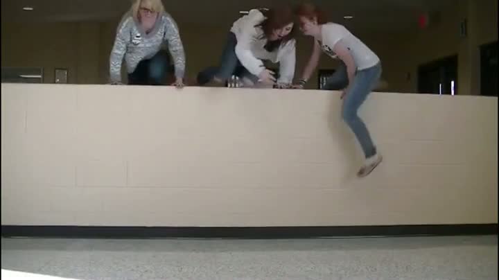 Three Girls Jump Over Wall
