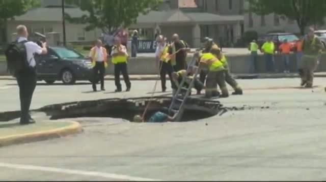 Woman Rescued After Driving Into Sinkhole