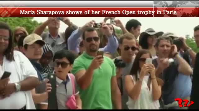 Maria Sharapova shows of her French Open trophy in Paris