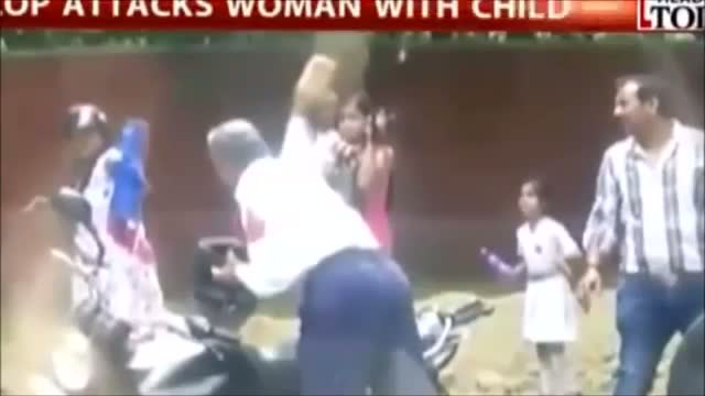 Delhi cop attacks woman with a brick