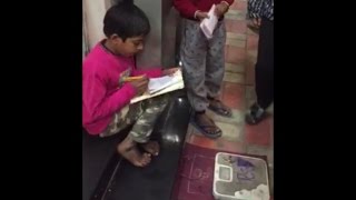 Poor kid fighting against all odds, studies on street with weighing machine at Kamla Nagar