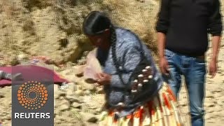 Bolivian Catholics break rocks to try luck