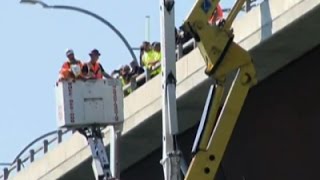 Raw: Two Rescued From Crane Hanging Off Bridge