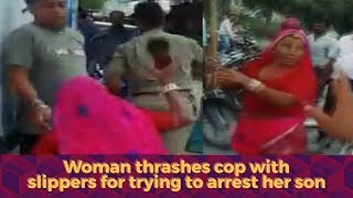 Woman thrashes cop with slippers for trying to arrest her drunk son