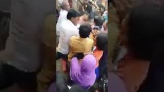 WOMEN FIGHTING WHILE EXCHANGING MONEY