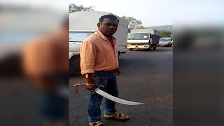 Local brandishes sword to threaten the other group for stopping his sand-laden truck from Kudal.
