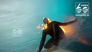 Surfer Jamie O'Brien lights himself on fire before riding massive wave