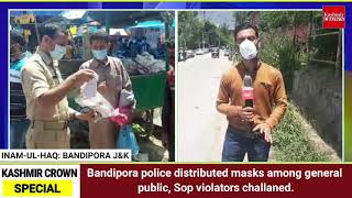 Bandipora police distributed masks among general public, Sop violators challaned.