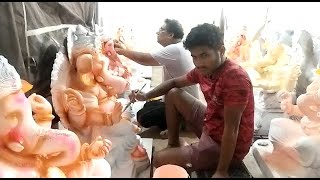 Artist giving final touches to lord Ganesh Idols