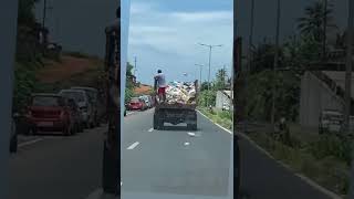 Open garbage truck with garbage flying on the Airport road near the new bridge in Vasco!