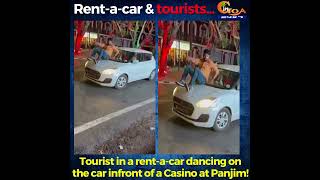 Tourist in a rent-a-car dancing on the car infront of a Casino at Panjim!