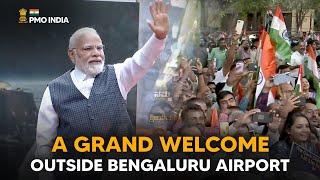Prime Minister Narendra Modi receives a grand welcome outside Bengaluru airport