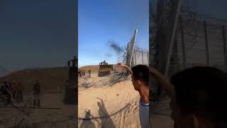 Palestinian bulldozer removing the separation wall on the Gaza Strip border