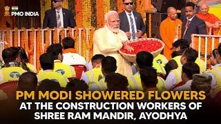 PM Narendra Modi showers flowers at the construction workers of Shree Ram Mandir, Ayodhya ji
