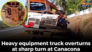 Heavy equipment truck overturns at sharp turn at Canacona.