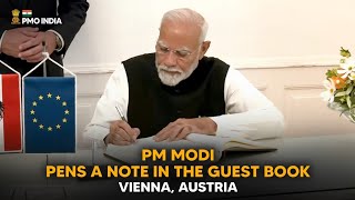 Prime Minister Narendra Modi pens a note in the guest book, Vienna, Austria l PMO