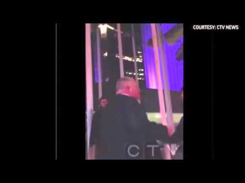 Mayor Rob Ford stumbling outside Toronto's City Hall and swearing loudly
