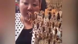 Stomach-Churning Moment Woman Eats Dozens of LIVE Scorpions in Chinese Food Market
